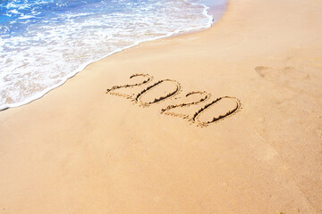 Number 2020 year on the sand sea shore