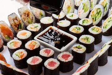 Various kinds of sushi roll set served on cutting board. Japanese food