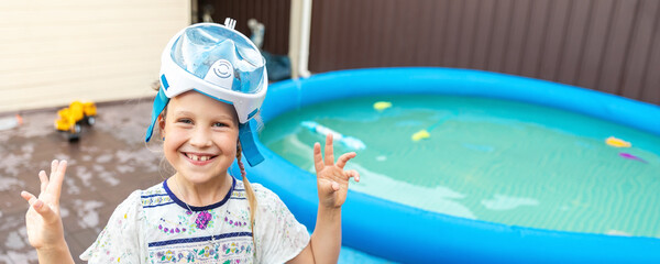 Cute adorable caucasian blond little girl making experiment try diving in pool with full face...