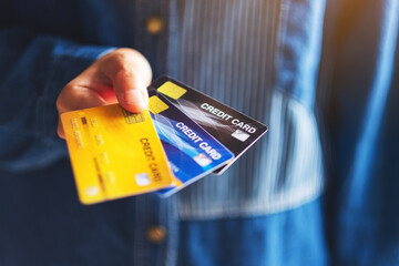 Closeup image of a woman holding and showing credit cards
