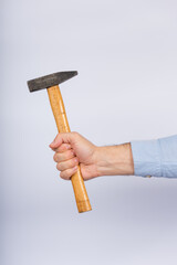 Male hand with hammer on white background. Claw hammer Side view.