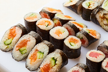 Various kinds of sushi roll set served on cutting board. Japanese food