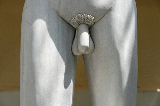 Detail marble statue of male genitals. Public sculpture detail of a young man in tropical garden in Danang, Vietnam
