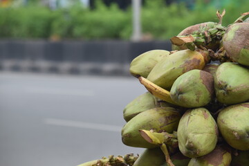 pile or group of coconuts on the cart at road for sells