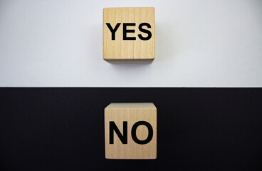 Yes and no, text on wooden cubes on a white and black background. The concept of choice. Truth and lie. Positive and negative.