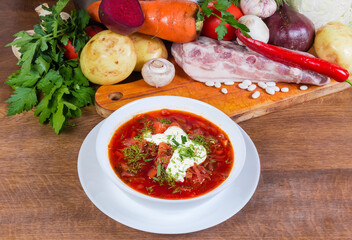 Red beet borscht against the several its raw ingredients