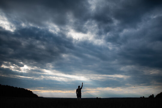 silhouette of a young guy against the sky