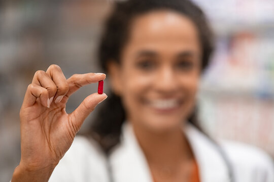 Pharmacist showing red pill