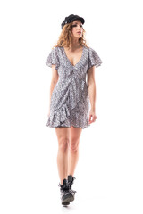 Self assured confident young woman walking relaxed looking away distracted at attention. Full length isolated on white background. 