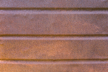 The rusty surface of the old metal perforated sheet