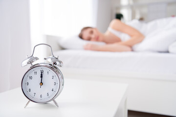 Blurry focus photo of charming lady sleeping bed white sheets blanket calm sure metal alarm clock...