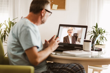 Businessman chatting with his colleague. Working at home.