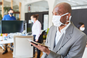 Businessman chatting with smartphone and face mask