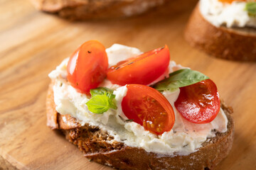 Close up of Italian bruschetta with cream cheese and red cherry .Detail