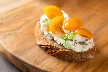 Close up of Italian bruschetta with cream cheese and tomato cherry .Detail