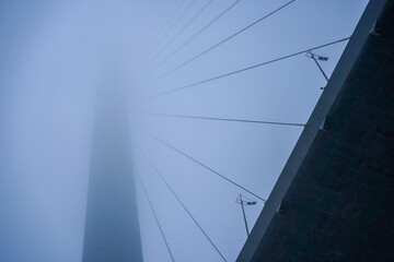 Fototapeta na wymiar Construction of the Golden bridge in the fog.