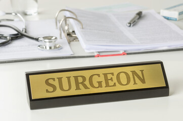 Name plate on a desk with the engraving Surgeon