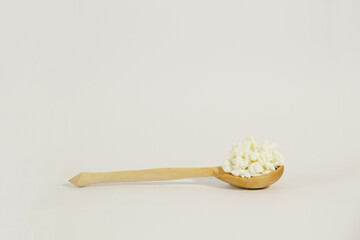 Cottage cheese on a wooden spoon. Concept healthy  food.