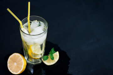 Summer refreshing cold lemonade Mojito on a dark table with copy space