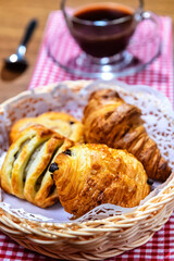 A Basket Of Bread On The Checks Table Mat