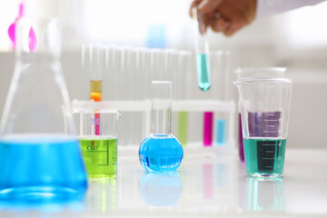 Chemical industry bulb with blue magenta pink liquid lab tubes stand on the table in the laboratory of liquid testing test development substances poisons additives stabilizers flavors house cleaning