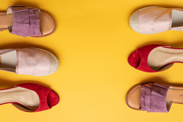 Various women's shoes on a colored background, top view. Top view, flat lay. Beauty blog concept.