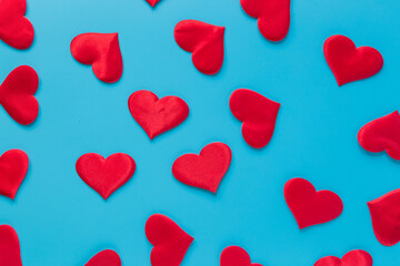 Red hearts on flat blue background. Medical or romance consept