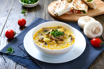 Vegetarian soup with champignons and vegetables. Mushroom soup for lunch.