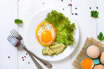 Fried eggs in a ring of yellow bell pepper. Healthy breakfast food. Proper nutrition. The top view
