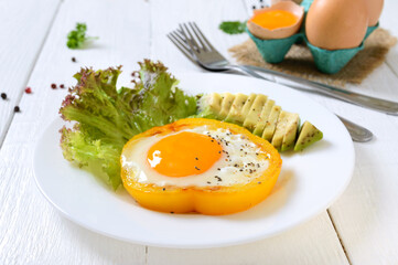 Fried eggs in a ring of yellow bell pepper. Healthy breakfast food. Proper nutrition.