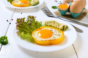 Fried eggs in a ring of yellow bell pepper. Healthy breakfast food. Proper nutrition.