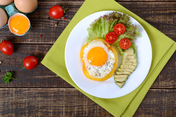 Fried eggs in a ring of yellow bell pepper. Healthy breakfast food. Proper nutrition. The top view