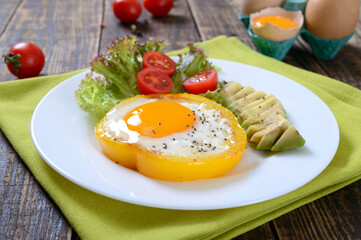 Fried eggs in a ring of yellow bell pepper. Healthy breakfast food. Proper nutrition.