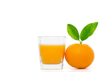 Orange juice in glass with oranges on white background.