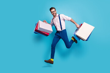 Full length profile photo of handsome business man carry bags jump high buy vacation stuff shopping...