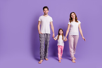 Fototapeta premium Full length body size view of nice cheerful cheery careful family mommy daddy adopted foster daughter wearing sleepwear bedtime isolated on bright vivid shine vibrant violet color background