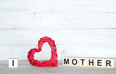 I love mother. The inscription on wooden cubes. On a white background. Red heart