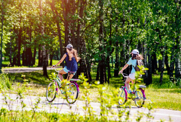 Fototapeta premium Cyclists ride on the bike path in the city Park 