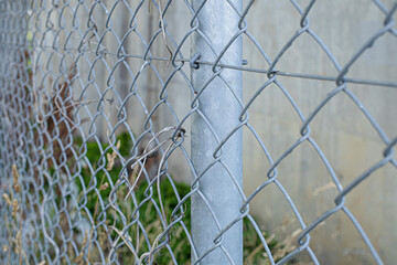 An old wire mesh with a diamond pattern.