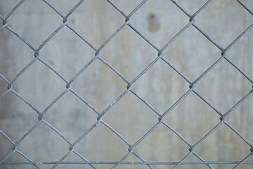An old wire mesh with a diamond pattern.