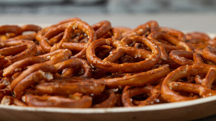 Pretzels on a plate on the kitchen table. Snack on beer. Salty snack. Crispy pretzels. Beer snacks