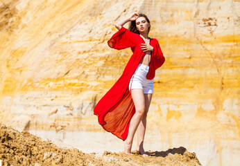 Full body portrait of a young beautiful brunette woman in red tunic