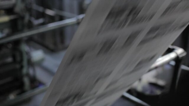 Close Up Newspaper Roll Rolling Through Print Press Machine