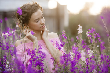 Very beautiful young woman with flowers. Close up portrait of attractive female
