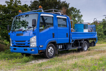 Front view of blue work truck with sirens