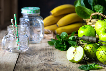 group of healthy green apples, spinach, bananas and mint are ingredients for a smoothie. Detox, diet, healthy, vegetarian food concept.