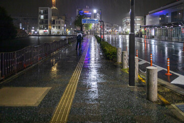 Single man with umbrella in heavy rain