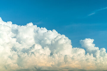 White fluffy clouds on blue sky. Soft touch feeling like cotton. White puffy clouds cape with space for text. Beauty in nature. Close-up white cumulus clouds texture background. Sky on sunny day.