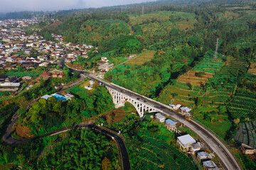 Morning view of Sigandul Bridge with Sindoro mountain baground.