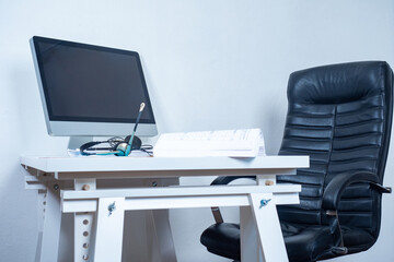 Empty workplace. A chair and a table with a laptop. Home office. Break in work. Desktop in the office. A place for office work.